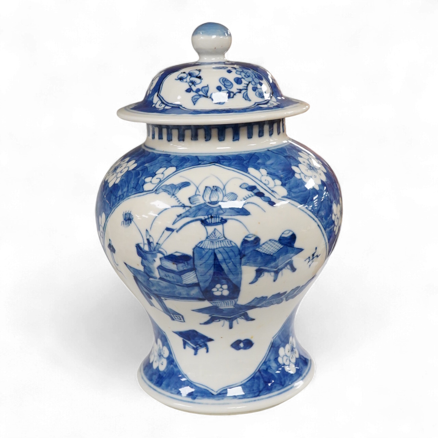 A late 19th century Chinese blue and white baluster vase and cover, decorated with precious objects against a cracked ice and prunus ground, 22cm